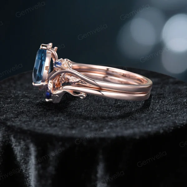 Side angle of the nature-inspired bridal set, showcasing the rose gold band's thickness, the layered design of the engagement ring and wedding band, and the setting of the blue topaz and sapphires.