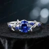 The nature-inspired leaf vine ring with a round blue sapphire, showcased in a brilliant sterling silver version for a modern and elegant style.