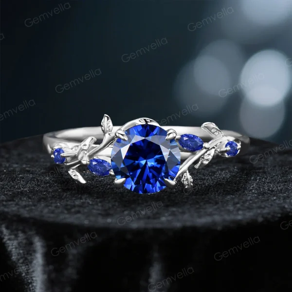 The nature-inspired leaf vine ring with a round blue sapphire, showcased in a brilliant sterling silver version for a modern and elegant style.